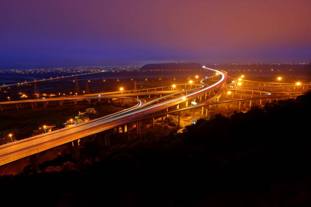 istock Aerial view of transporting structures with highway and interchange at night, 1386169075