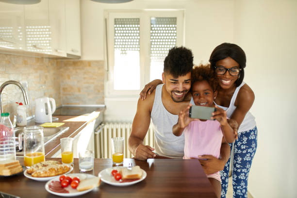 istock Cheerful family taking Selfie during breakfast 1386170509