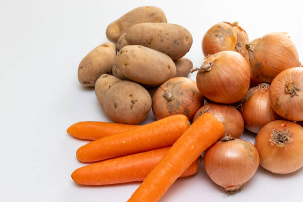 istock Onions, potatoes and carrots on the table 1386170724
