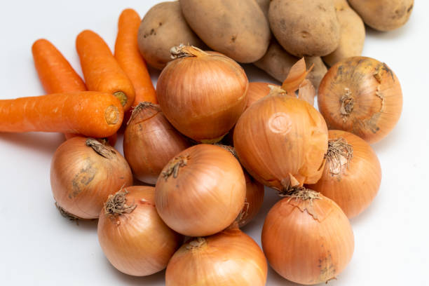 istock Onions, potatoes and carrots on the table 1386170728