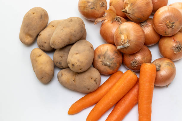 istock Onions, potatoes and carrots on the table 1386170731