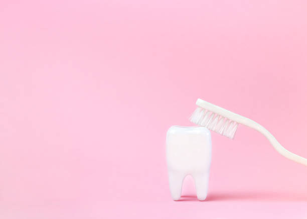 istock tooth mockup and toothbrush on pink background 1386171985
