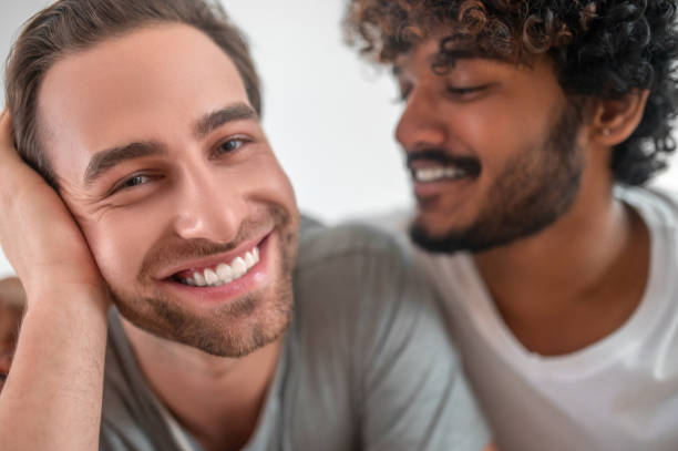 istock Curly-haired guy gazing at his handsome boyfriend 1386172447
