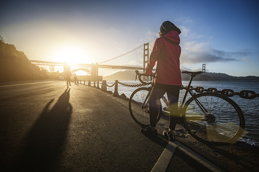 Bicycle riding in San Francisco: commuter with racing bike by the Golden Gate Bridge