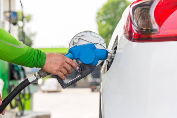Hand Man Refill and filling Oil Gas Fuel at station. Gas station - refueling. To fill the machine with fuel. Car fill with gasoline at a gas station. Gas station pump stock photo