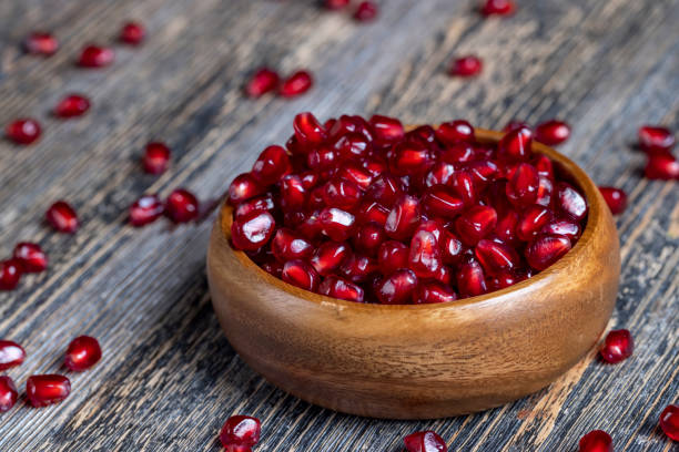 istock scattered pomegranate seeds on a wooden board 1386175703