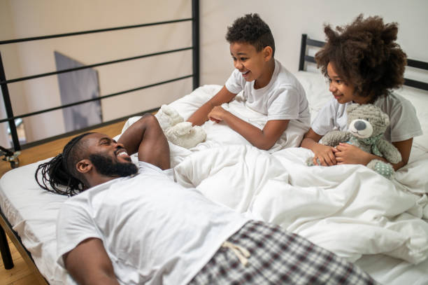 istock Father lying telling and interested listening children 1386176489