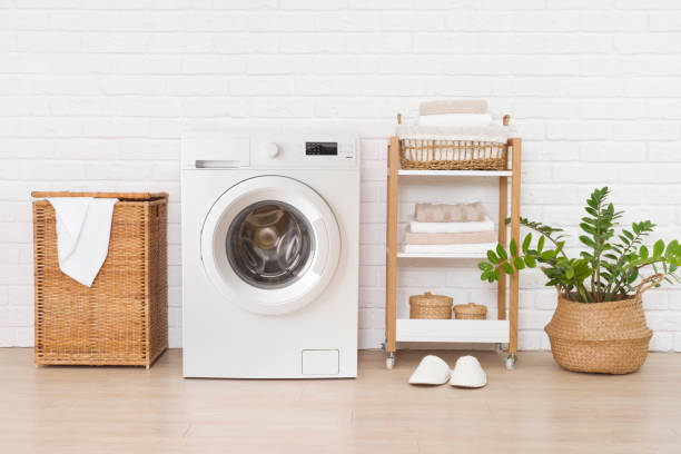 istock Laundry room interior with modern washing machine near brick wall 1386179078