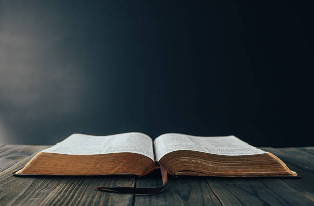 istock open Holy Bible on the wooden table 1386180752