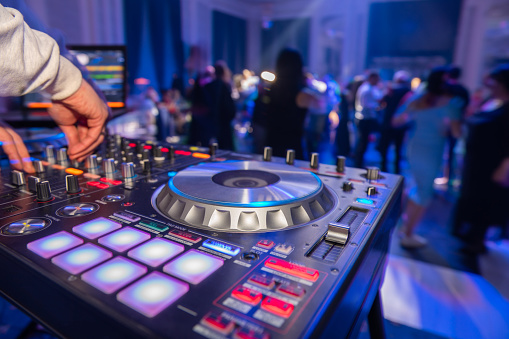 Dj mixing music at a party.