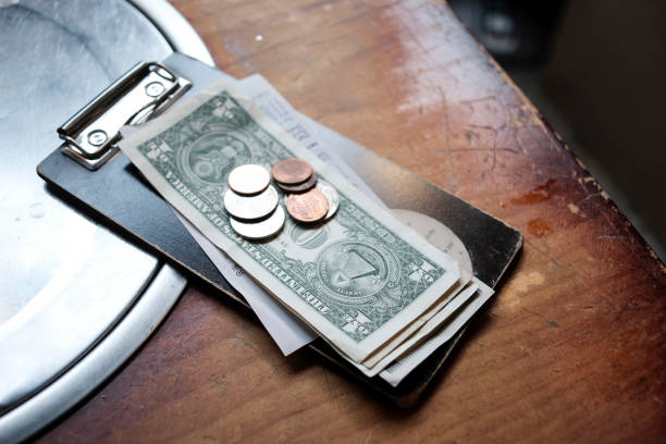 istock Tip money on restaurant's table.Change money on table 1386181323
