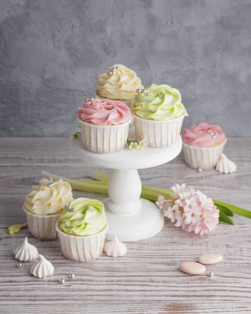 istock Spring pastel colored cupcakes and flowers 1386181492