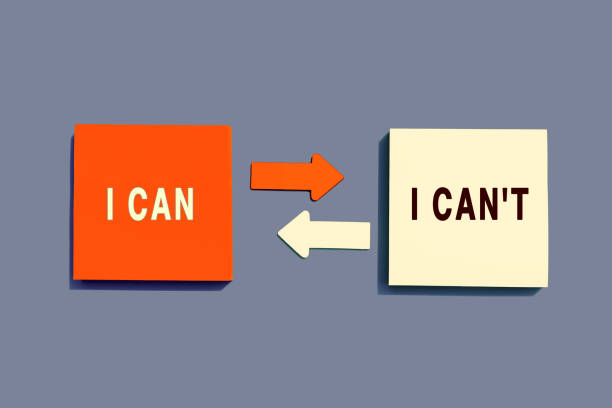 istock Note paper with arrows between the options of I Can or I Can't on grey background, top view. Motivation Concept 1386182800
