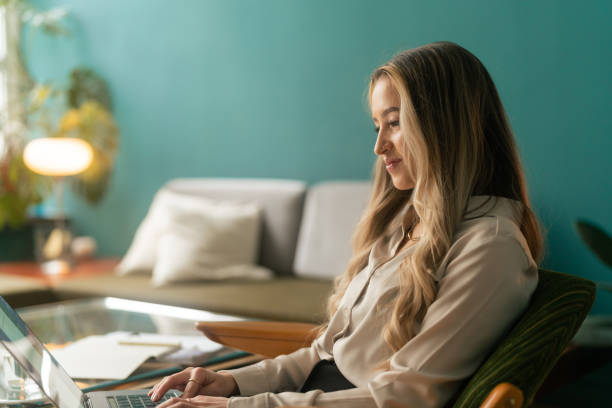 istock Woman doing some work on her laptop at home 1386184804