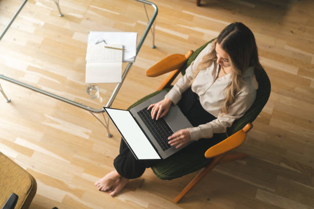istock Woman doing some work on her laptop at home 1386184837