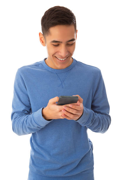 iphoneでテキストを読んで微笑む若い大人の男性 - text messaging mobile phone teenagers only people ストックフォトと画像