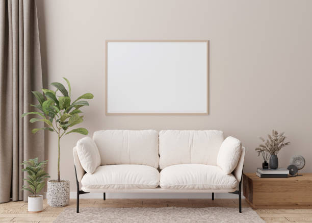 istock Empty horizontal picture frame on cream wall in modern living room. Mock up interior in scandinavian style. Free, copy space for your picture, poster. Sofa, table, dried grass, books. 3D rendering. 1386190764
