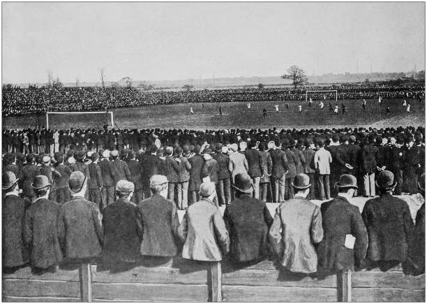 antike schwarz-weiß-fotografie von england und wales: fußballspiel in manchester - soccer stadium sport crowd stock-grafiken, -clipart, -cartoons und -symbole