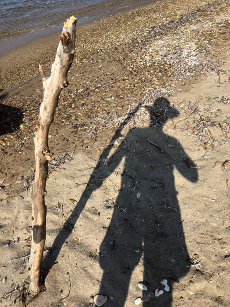 istock Shadow of a man with hat at the beach 1386190997