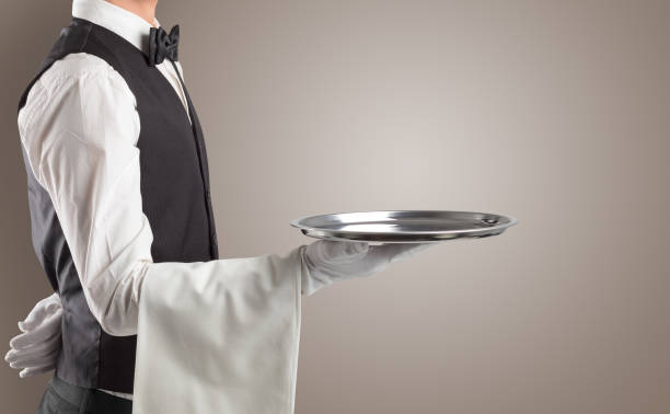 istock Waiter serving with white gloves and steel tray 1386191079