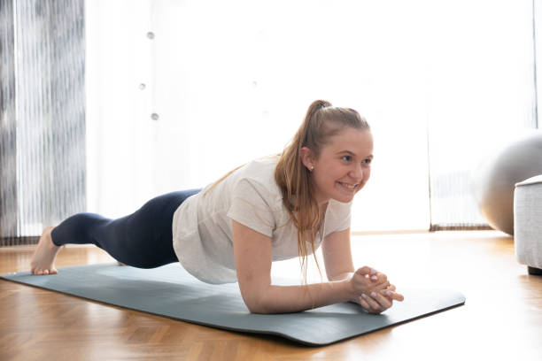 istock Young woman working out at home 1386193750
