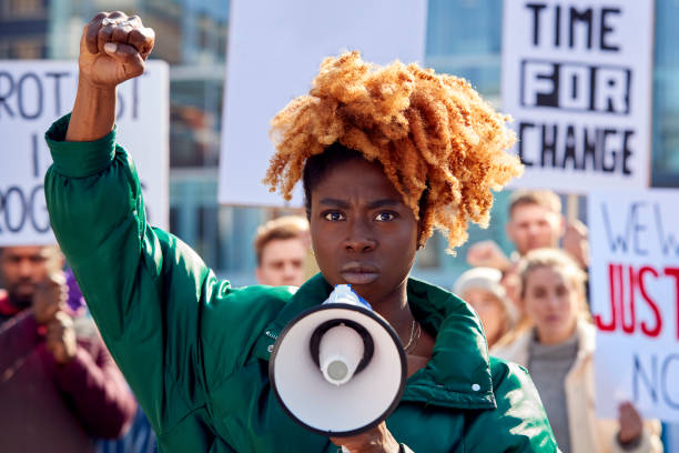 istock Protestors With Placards And Megaphone On protests Demonstration March Against Racism 1386198029