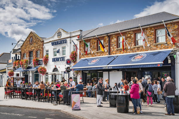 People enjoying nice weather in Dublin Howth and dining outdoors, Ireland stock photo