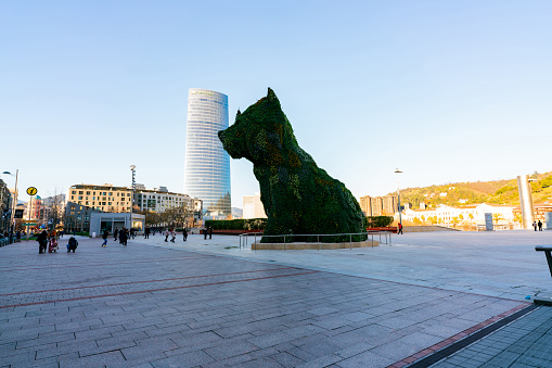 BILBAO, SPAIN-DECEMBER 18, 2021 : Puppy stands guard at Guggenheim Museum in Bilbao, Biscay, Basque Country, Spain. Landmarks. Dog sculpture of artist Jeff Koons. The World\