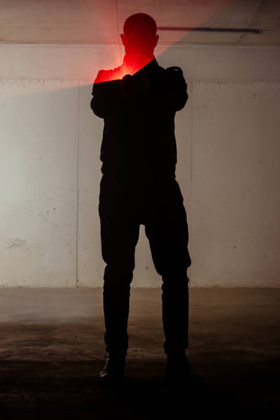 istock Silhouette man holding laser pistol 1386207091
