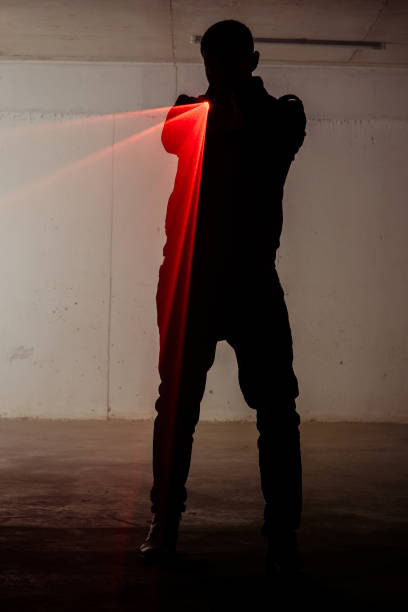 istock Shadow of a man holding laser 1386207092