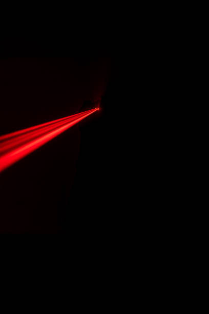 istock Man with gun standing in dark room 1386207094