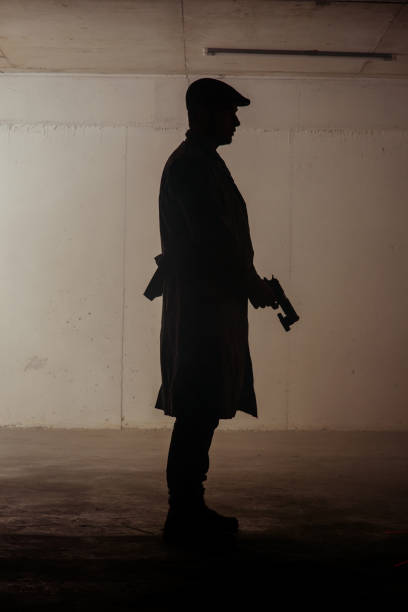 istock Figure of a man holding revolver 1386207105