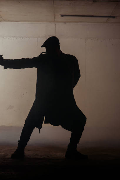 istock Silhouette of a man with weapon 1386207106