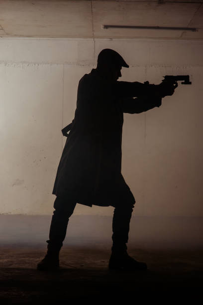 istock Portrait of a man with gun 1386207108