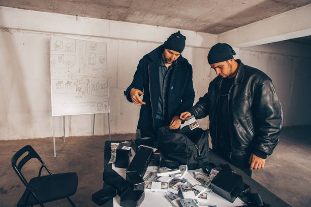 istock Adult thieves counting cash 1386208286