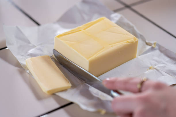 istock Cutting a slice of butter in a kitchen. Close-up 1386208473
