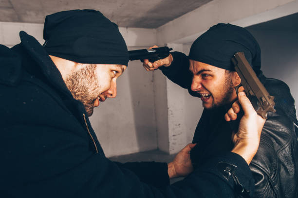 istock Gangsters having a fight with the guns 1386208561