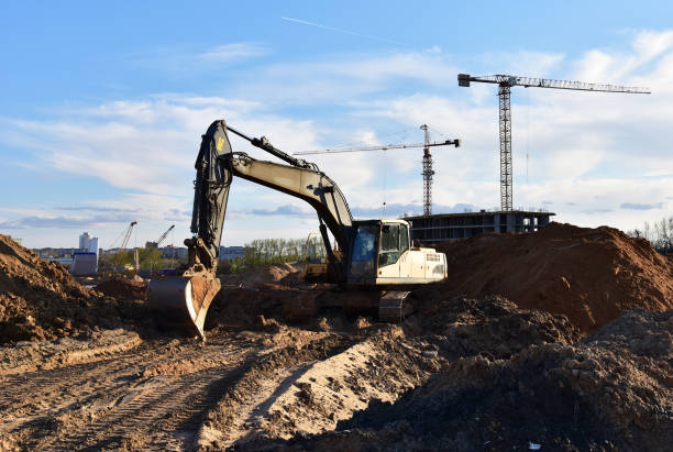 istock Excavator on earthmoving at construction site. Excavator on earthworks. Loader digg ground. 1386210014