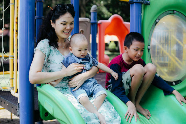 istock happy family enjoying playing on playground 1386210018