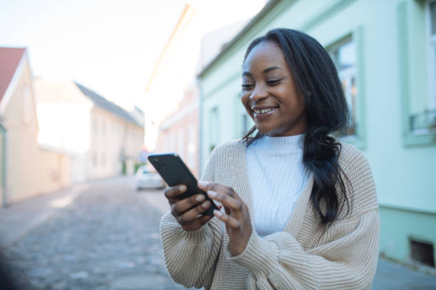istock African woman using smart phone outdoors 1386213127