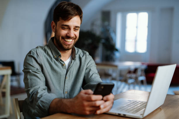istock Man sitting and working on laptop 1386213186