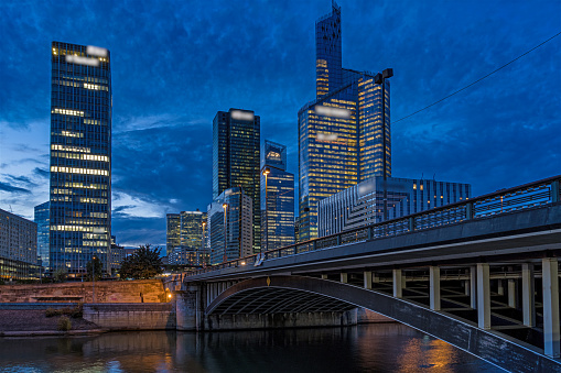 Timelapse - Blue Hour With Cloudy Sky Over La Defense Business District With Seine River and Bridge. Find more images of LA DEFENSE on my profile.