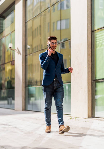 istock Modern businessman on mobile phone in urban place 1386214629