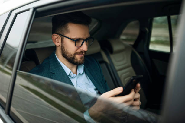 istock Young businessman in back seat 1386215172