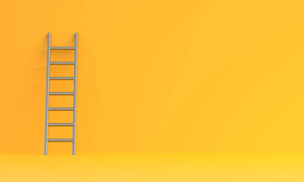 escalera sobre un fondo de pared amarillo - ladder fotografías e imágenes de stock