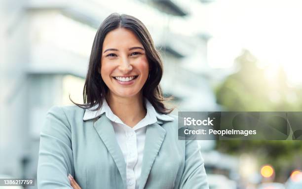 Portrait Of A Confident Young Businesswoman Standing Against An Urban Background Stock Photo - Download Image Now