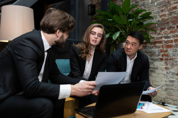 istock Multinational business people group brainstorm at office meeting. Multiethnic professional employees team talking engaged in teamwork discussing improvement plan analysis and share ideas at work 1386222776