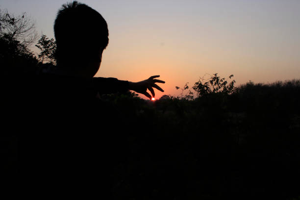 istock A man trying to catch the sun 1386225365