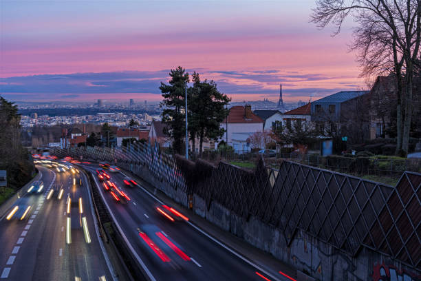 istock Pink Sky Over Paris at Sunrise With Highway Traffic 1386228471