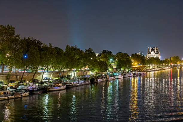 istock Night Traffic at Paris Famous Monuments Seine River Boats Docks and Bridge 1386229280